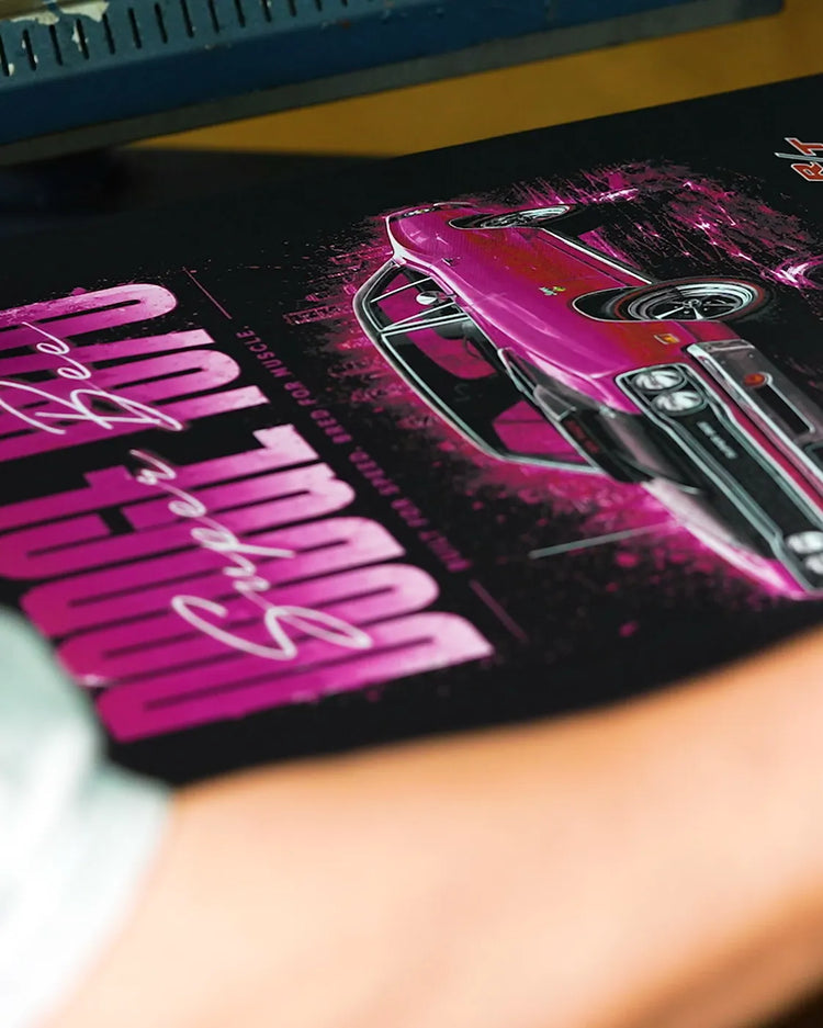 Hand smoothing a freshly pressed print on a black T-shirt