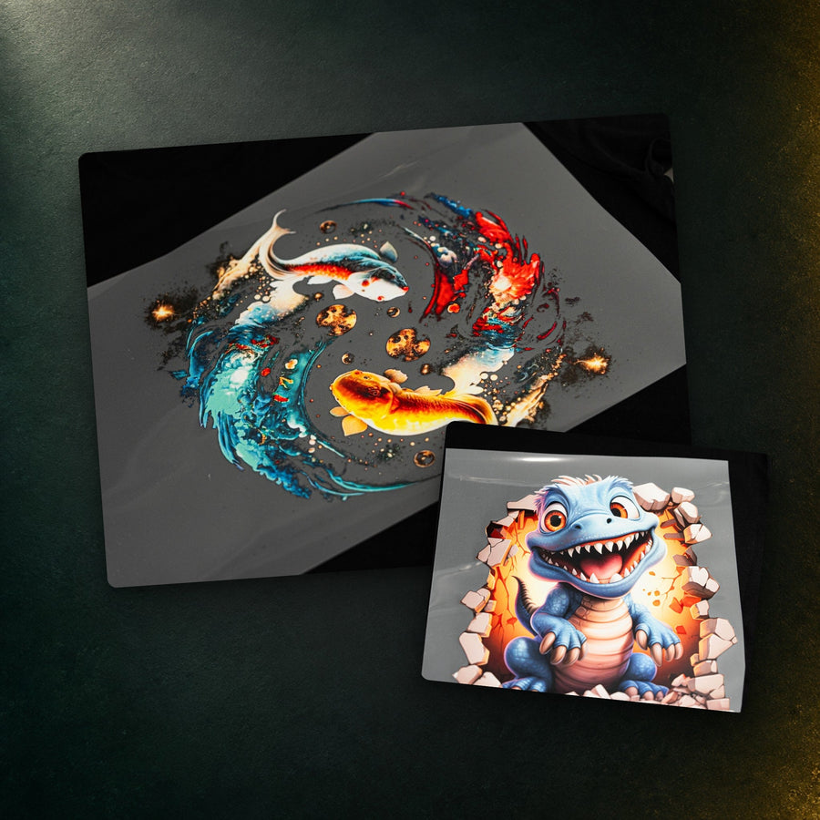 DTF gang sheet transfers printed by DTF Complete: a koi fish design and a cartoon dinosaur design on PET film