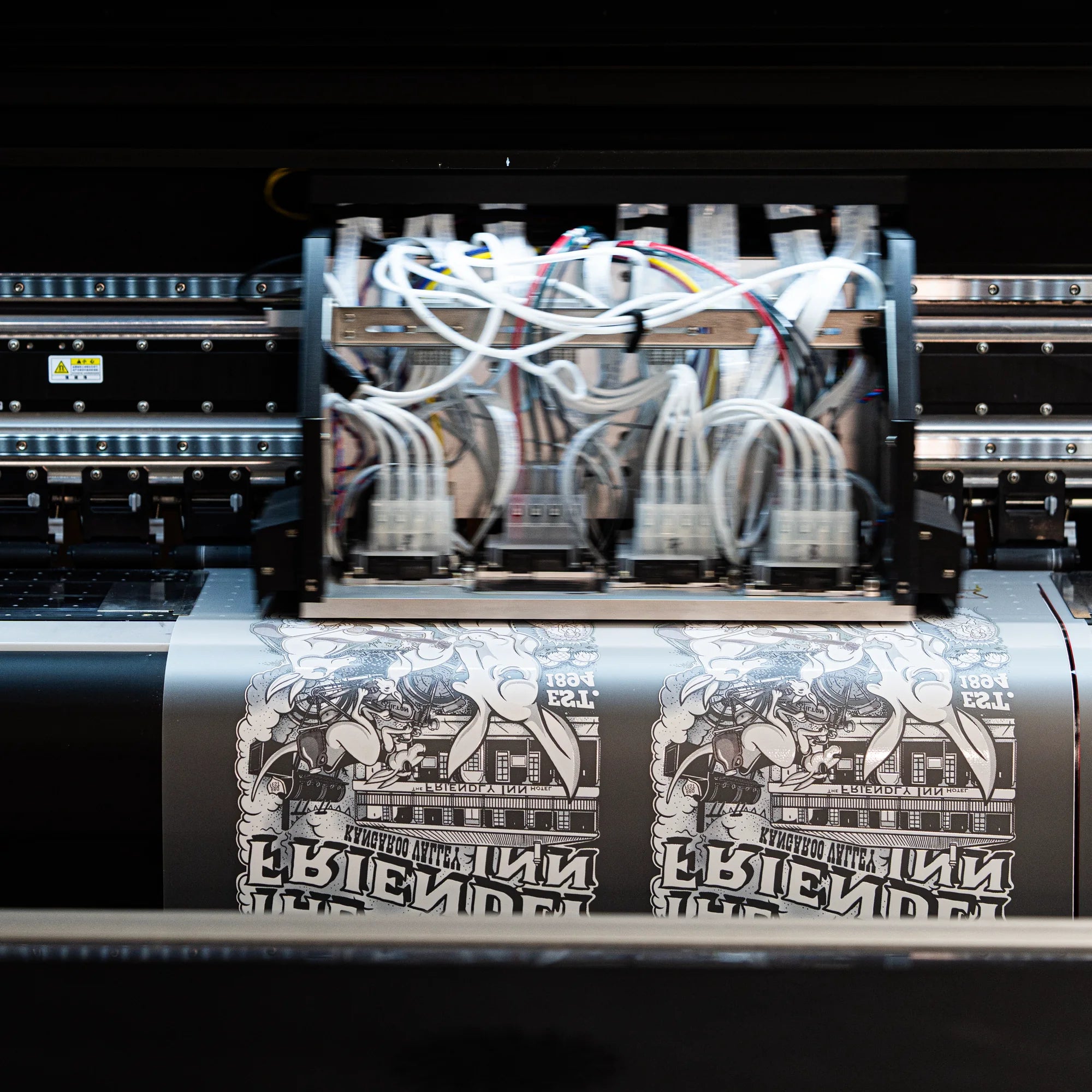 DTF transfer film moving through the production printer
